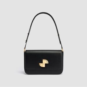 Patou Le Lock Shoulder Bag is a black calf leather